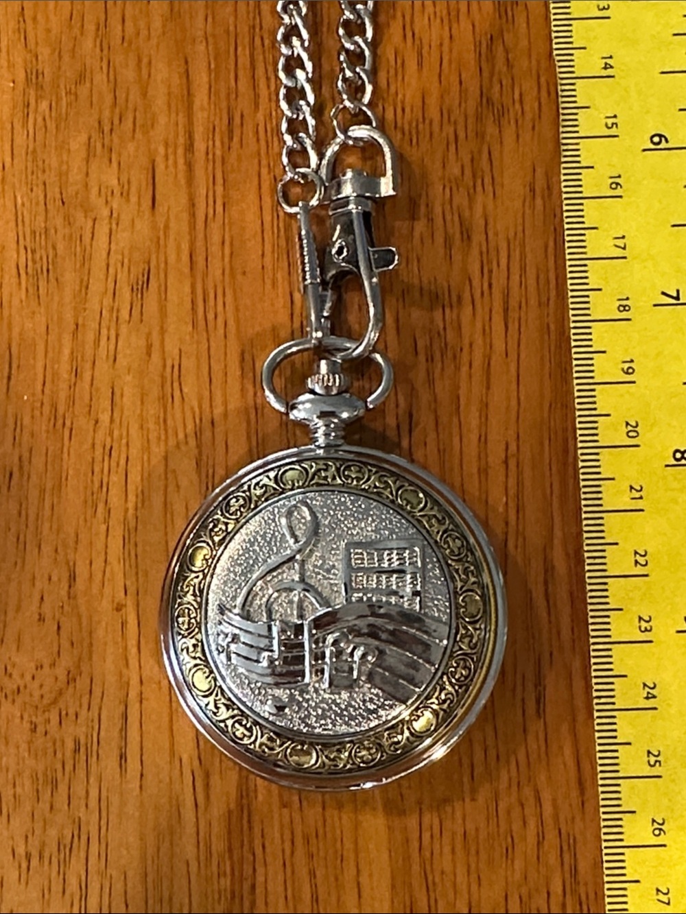 Shoppe Watch Men’s Musical Note Pocket Watch. 2” Two tone with white face.
